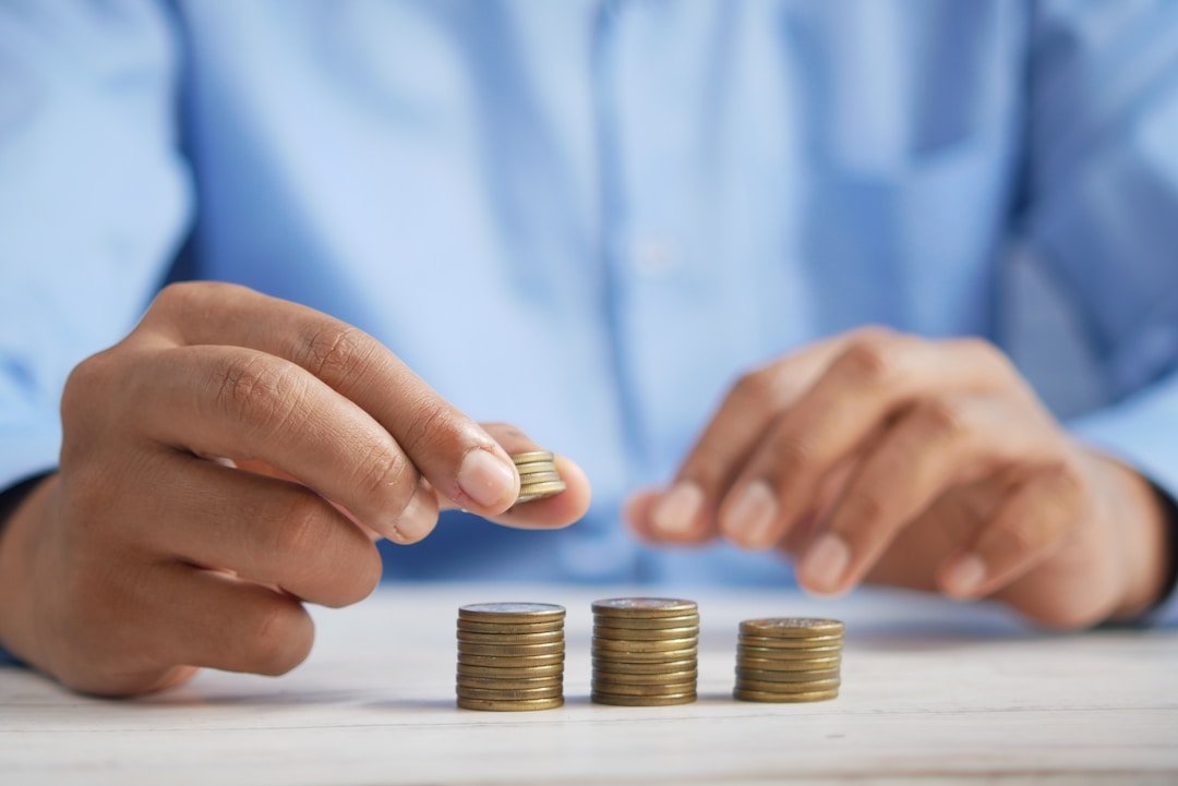 Businessman stacking coins representing the necessity for accounting for start ups